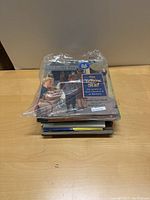 Stack of 11 hardback children's books wrapped in plastic showing titles including 'The Yellow Star'