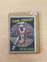 Front of 1959 Topps #435 Frank Robinson baseball card showing player in Cincinnati Redlegs uniform with black background and yellow text.