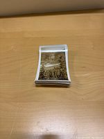 Stack of black and white photo realistic postcards showing Alaskan Highway landscape scenes, unposted and slightly bent.