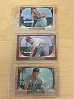 Front view of three 1955 Bowman baseball cards in protective sleeves featuring Jim Greengrass, Willie Jones, and Irv Noren.