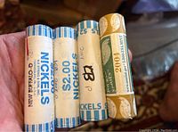Four unopened rolls of nickels including one roll of Buffalo nickels and three rolls of 2004 Westward series nickels in paper wrappers.