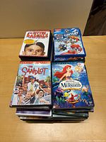 Stack of Children's Movie DVDs including The Little Mermaid, The Sandlot, Paw Patrol Winter, and Dr. Doolittle 3.