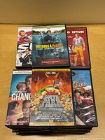 Top view showing a small selection of comedy DVD covers including Spy, Dirty Grandpa, Without a Paddle, Change-Up, South Park, and City Slickers.