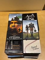 Stack of DVDs featuring The Blind Side promo, Remember The Titans, Don King Only In America, and Bull Durham Special Edition.