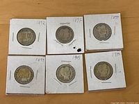 Six Barber Head quarters from Philadelphia without mint marks, dated 1892, 1897, 1899 (2 coins), 1903, and 1910, each in cardboard holders.