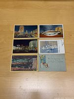 Front of six vintage postcards showing colorful cityscape, fish, nature, and Easter holiday themes.