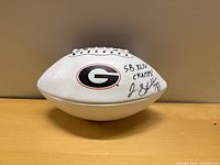 Full view of signed UGA football showing signature and inscription