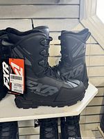 Side view of FXR X-Cross Pro snowmobile boots showing overall design, black color, and branding on boots