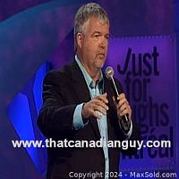 Glen Foster performing on stage with microphone and Just for Laughs backdrop