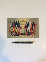 Flat view of WWI Allies Flags handout with pen below for size reference