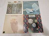Four classical music LP vinyl records with artwork and text on covers including Mozart, Holst, Chopin, and others.