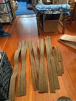 Multiple cork track base pieces laid out on floor, showing their length and width variation.