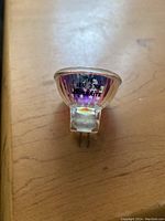 Close-up photo of Bulbrite 12V 20W halogen bulb with 2-pin base for crystal fixtures.