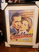 Full view of Casablanca framed movie poster with portrait of Humphrey Bogart and Ingrid Bergman, showing mint condition and frame corners covered.