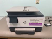 Front view of HP OfficeJet Pro 9120e all-in-one printer showing branding and front output tray.
