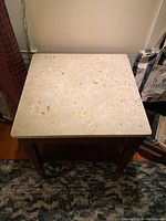 Top view of square marble top showing cream color and some veining.