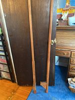 Full view of the pair of wooden stilts, showing their solid maple construction and length.