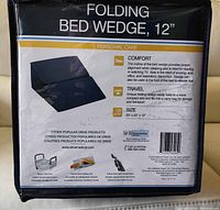 Photo of packaging showing product name 'Folding Bed Wedge, 12' and features including comfort, travel ease, and size 23" x 23" x 12".