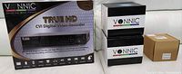 Wide shot of the boxed Vonnic True HD CVI DVR unit, three black boxes containing security cameras, and a brown box labeled Power & Video Balun