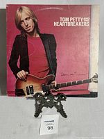 Front cover of the album showing Tom Petty with guitar on red background and album title