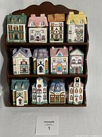 Full front view of the three-tier wooden rack holding all 12 ceramic cottage spice jars.