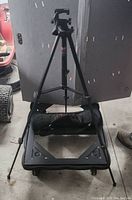 Full-length shot of the Blacks BX35 camera tripod standing on the floor, showing the adjustable legs and tripod head.