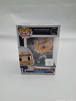 Front view of boxed Funko Pop! figure of Justin Herbert in Los Angeles Chargers uniform, showing figure number 162 and NFL logo