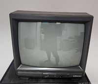 Front view of a black Emerson CRT tube TV showing screen and front panel controls
