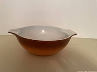 Side view of the large Pyrex bowl showing brown exterior and pouring handle