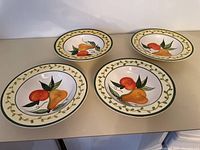 Four Stoneage handpainted Peramela soup bowls with fruit designs and vine borders