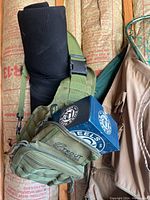 Green chest pack, black rod sleeve, blue reel box and strap