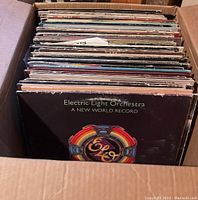 Cardboard box filled with vinyl LPs, Electric Light Orchestra – A New World Record visible at front
