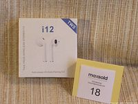 Front view of unopened retail box of i12 True Wireless Stereo earbuds showing product image and model name.