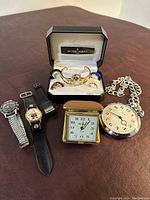 Photo showing full assortment of watches and clocks on table