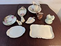 Collection on tabletop showing all items sold including Haviland-France platters, ceramic basin and pitcher, vases, and decorative pieces.