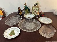 Wide arrangement showing all Christmas dishes, plates, glass platters and figurines on table