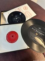 Close-up image of some of the twelve 7-inch records included in the set with visible Columbia Modern Language Course labels.