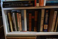 Bookshelf middle shelf showing various history and sociology books including Lincoln and Conspiracy