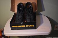 Pair of DeWalt Plasma work boots in original box, overhead view showing boots from front.