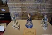 Overhead view of both figurines on display with certificate card between
