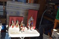 All Lenox Christmas figurines displayed on a white table, including three Celebration of Santas and one Sinterklaus Comes Riding, with boxes.