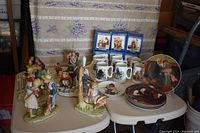 Full lot showing six porcelain tankards in boxes, five plates stacked with Norman Rockwell images, and multiple Dave Grossman figurines including the Four Seasons piece.
