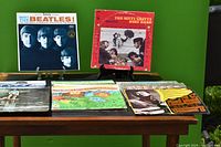 Photo showing 7 vinyl albums including The Beatles and The Nitty Gritty Dirt Band front album covers.