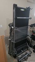 Folded Horizon Fitness treadmill secured and wrapped for storage.