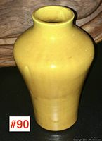Front and side view of the yellow glazed pottery vase showing shape and color