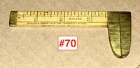 Full view of the antique wooden ruler with brass calliper end, showing measurement scale and manufacture markings.