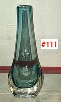 Front view of a tall blue and clear glass vase showing the Sommerso technique with clear outer glass and blue inner glass layer