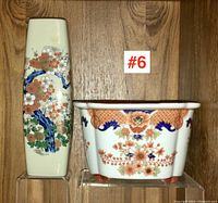 Side-by-side image of the tall Japanese vase and rectangular cache-pot plant pot placed on clear stands against wood background.