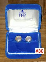 Pair of pearl earrings presented in a blue velvet box with satin lining, showing overall presentation and condition.