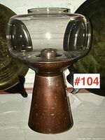 Front view showing the full lamp with bronze base and clear glass shade.